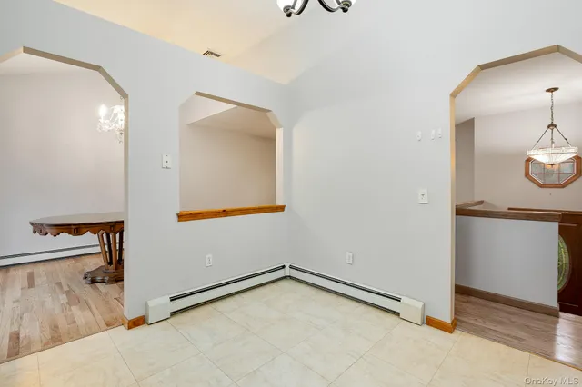 a view of a room with a sink and cabinets