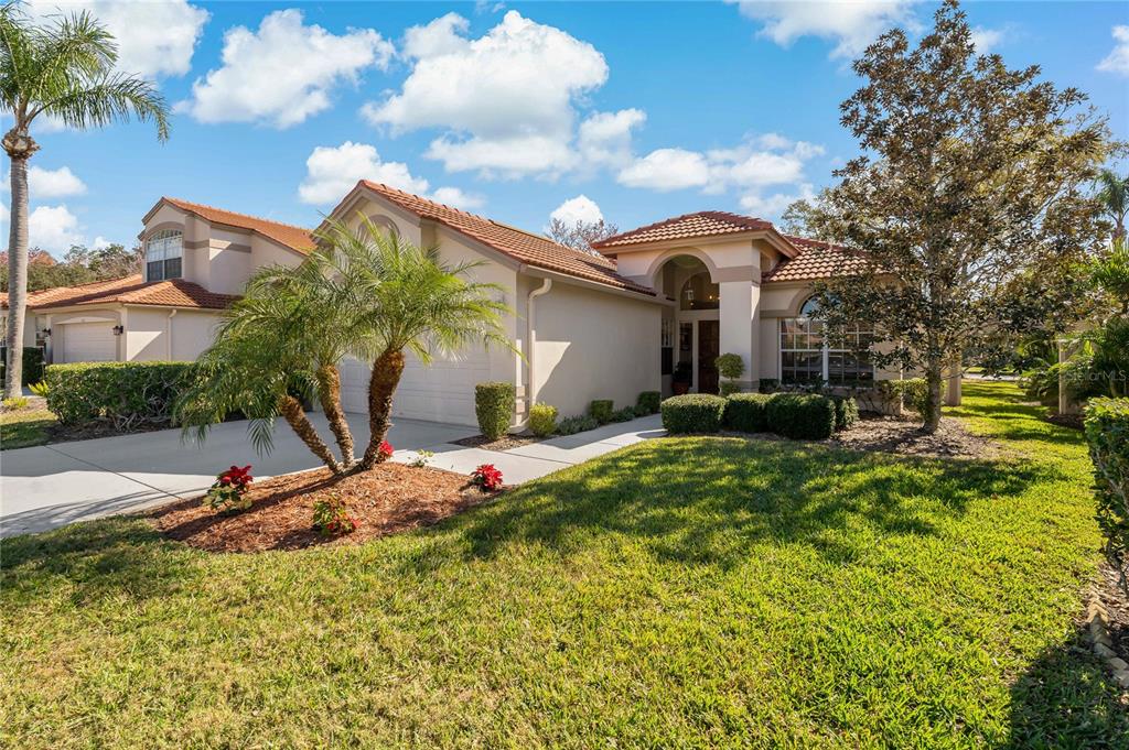 1111 Dartford Drive Tarpon Springs, FL 34688 - Photo 1 of 1 a front view of a house with garden