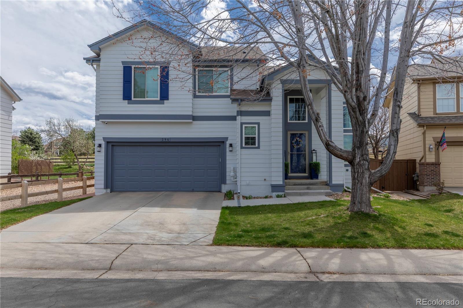 294 West Willowick Circle Highlands Ranch, CO 80129 - Photo 1 of 37 a front view of a house with a yard and garage