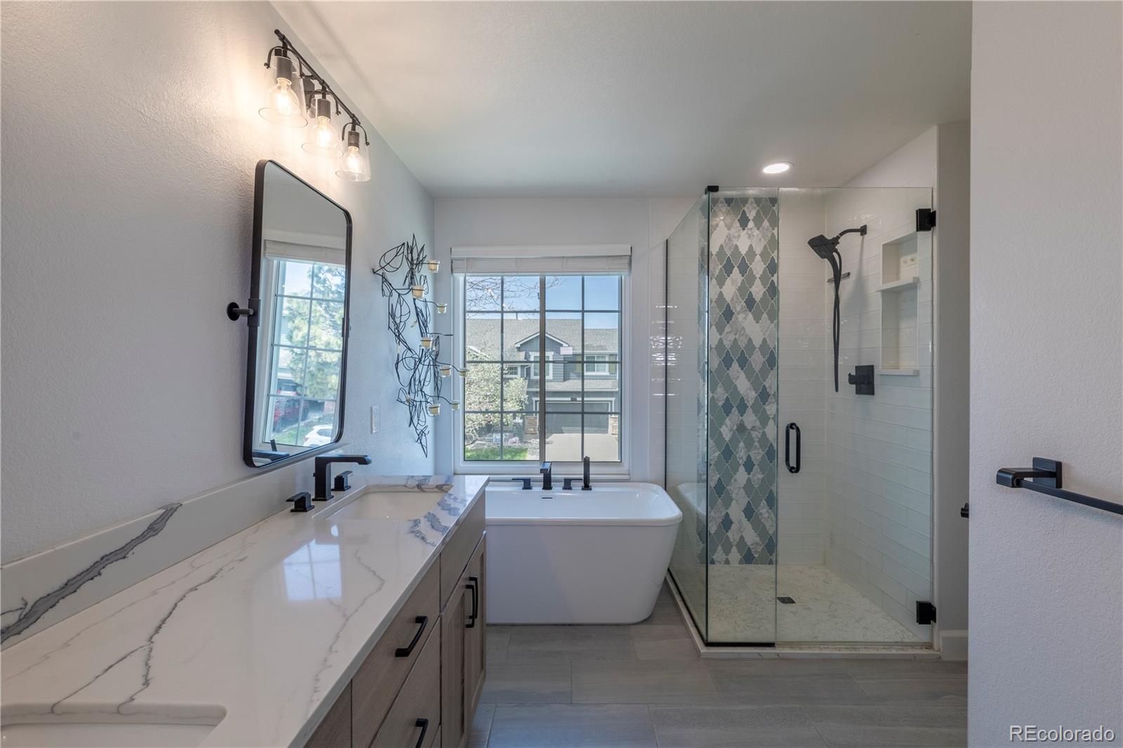 294 West Willowick Circle Highlands Ranch, CO 80129 - Photo 14 of 37 a bathroom with a tub sink shower and mirror