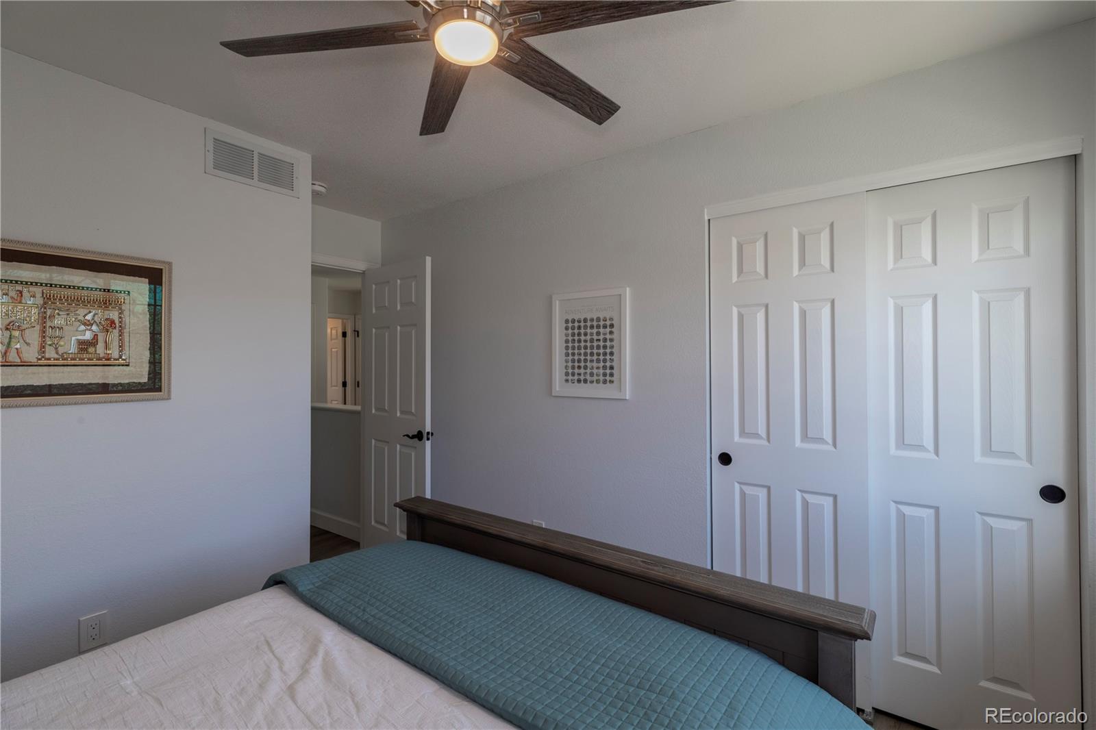 294 West Willowick Circle Highlands Ranch, CO 80129 - Photo 17 of 37 a bedroom with a bed and a chandelier fan