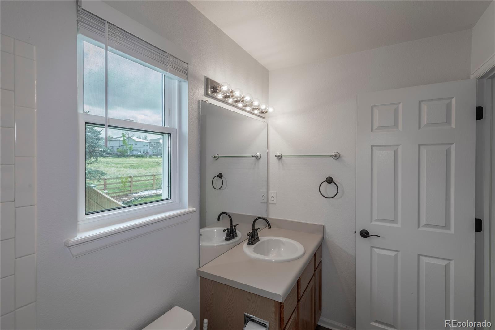 294 West Willowick Circle Highlands Ranch, CO 80129 - Photo 18 of 37 a bathroom with a sink and a mirror