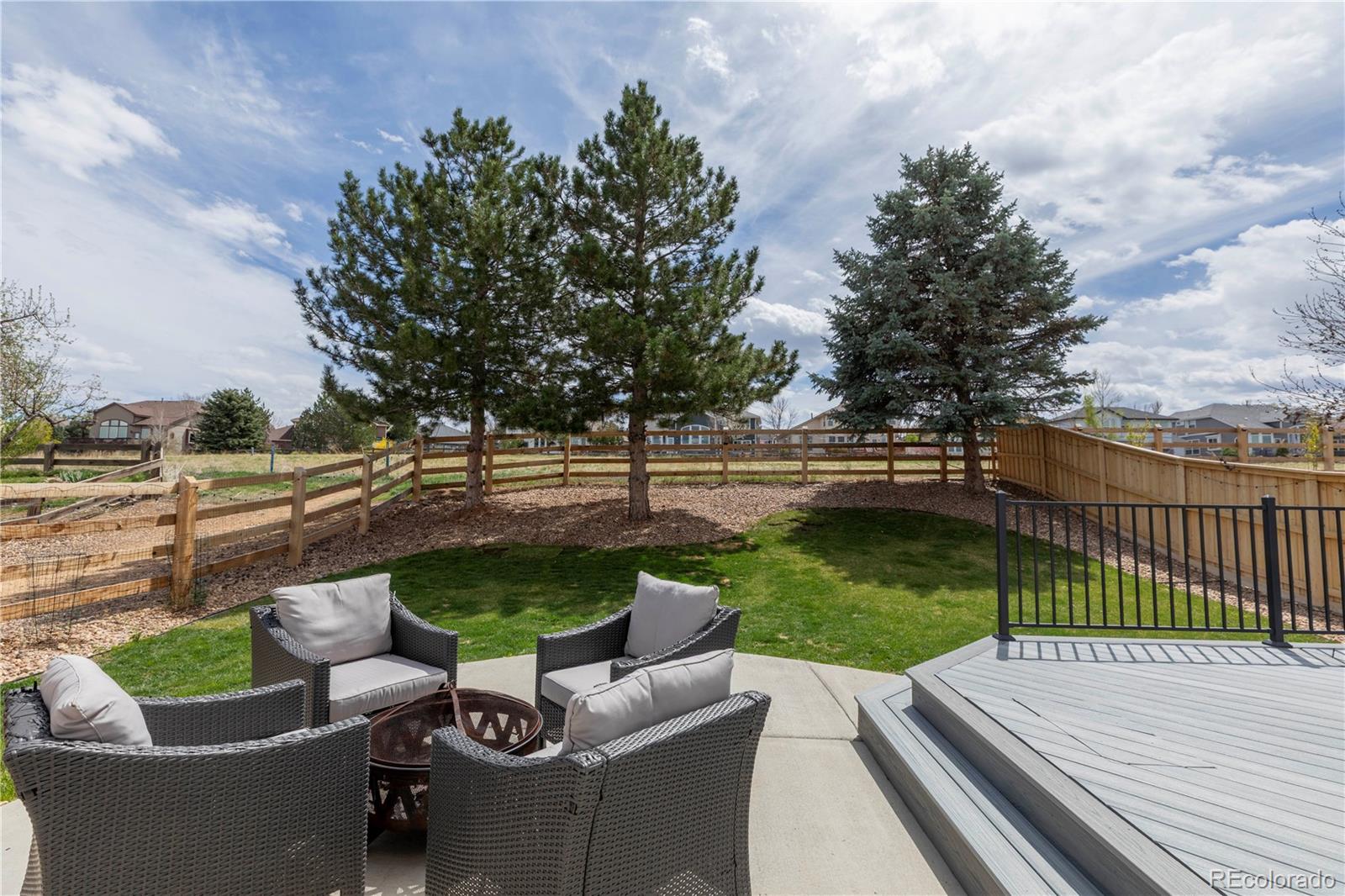 294 West Willowick Circle Highlands Ranch, CO 80129 - Photo 27 of 37 a view of a patio with couches potted plants and a big yard
