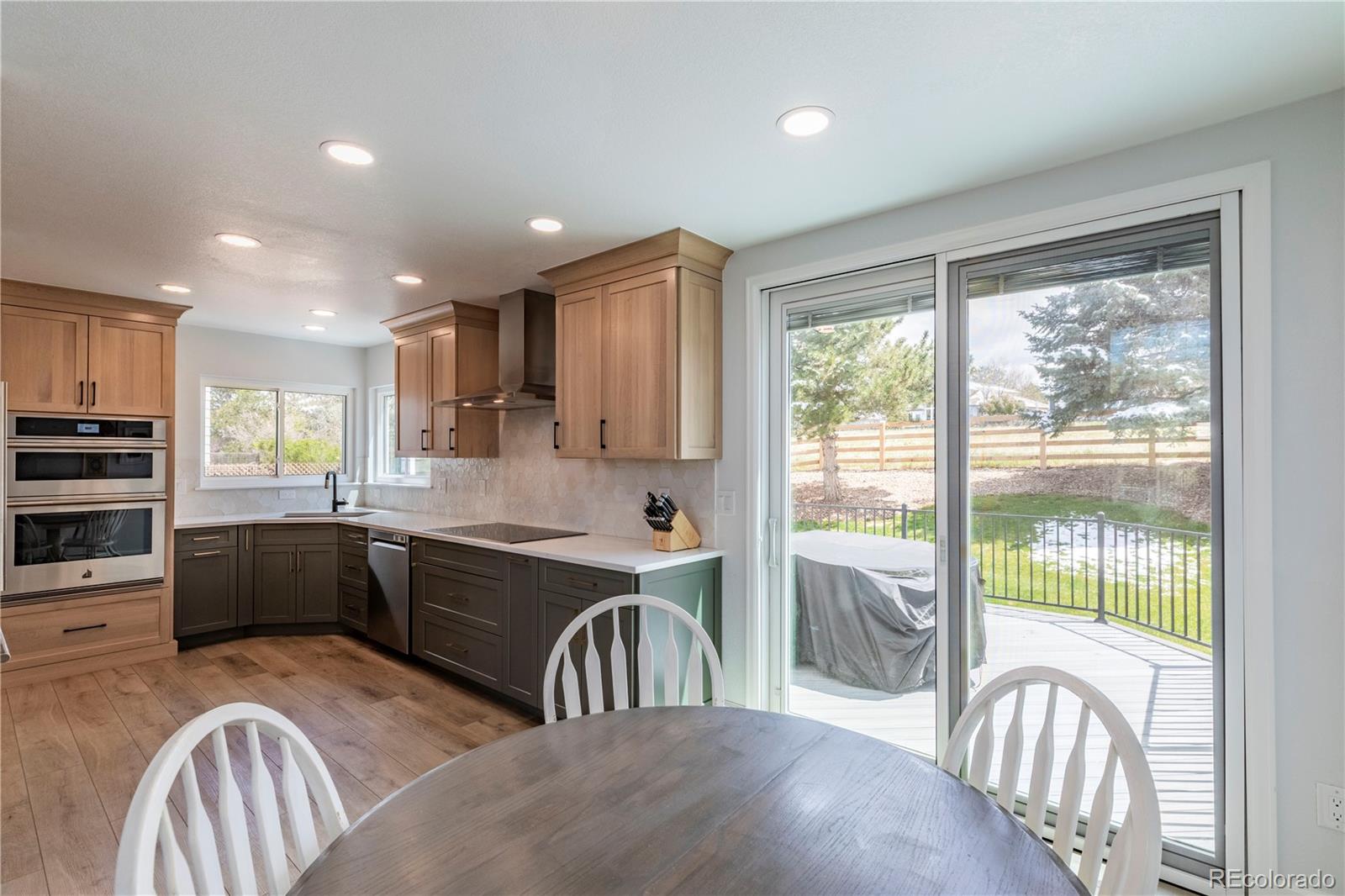 294 West Willowick Circle Highlands Ranch, CO 80129 - Photo 8 of 37 a large kitchen with kitchen island granite countertop a large window and stainless steel appliances
