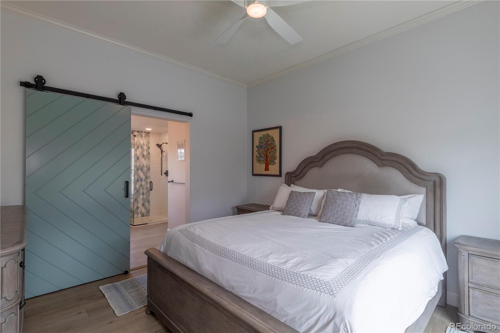 294 West Willowick Circle Highlands Ranch, CO 80129 - Photo 10 of 37 a bedroom with a bed and a chandelier