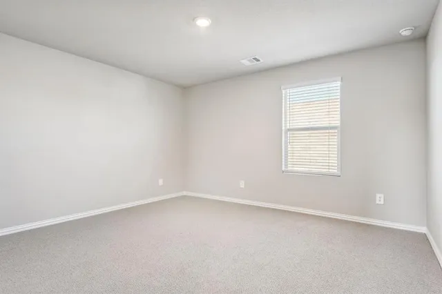 a view of an empty room and a window