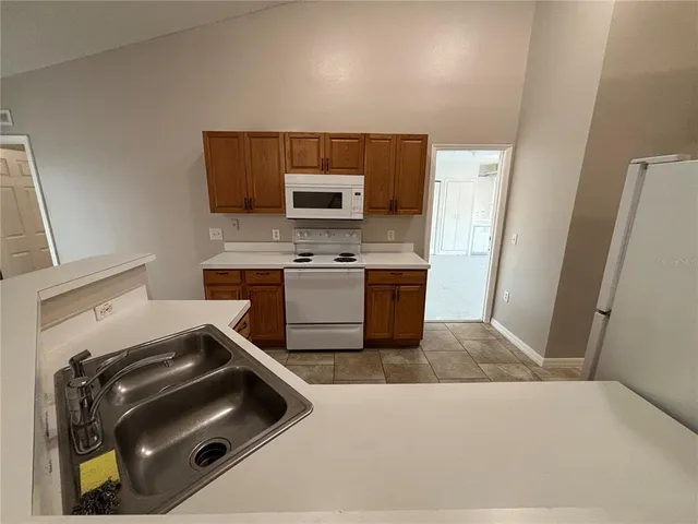 a kitchen with a sink stove and microwave
