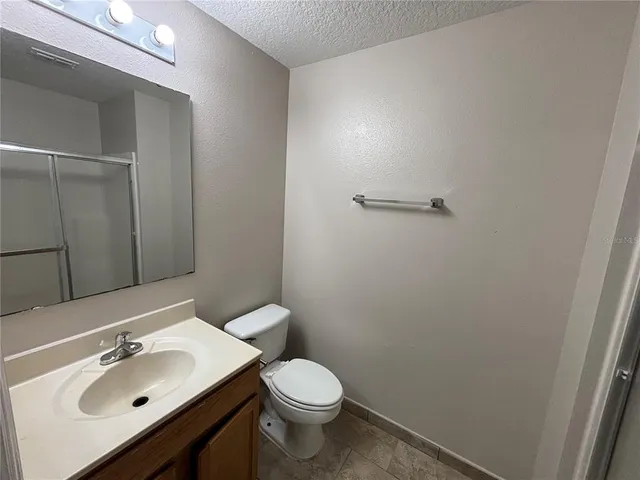 a bathroom with a sink toilet and mirror