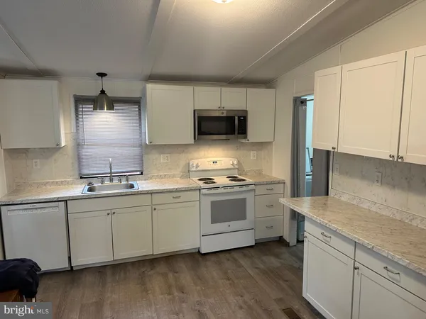 a kitchen with a sink stove and microwave