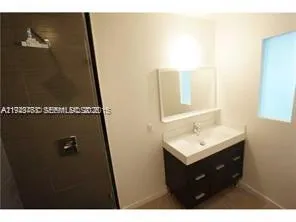 a bathroom with a sink a mirror and vanity