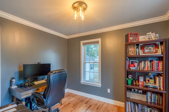a view of a livingroom with workspace and a window