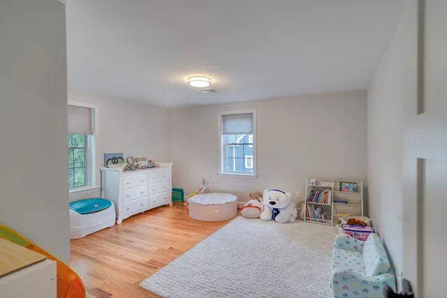 a bedroom with furniture and a wooden floor