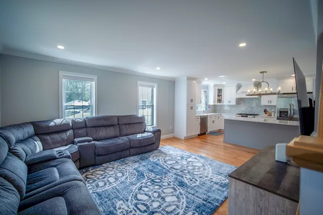 a living room with furniture and kitchen view