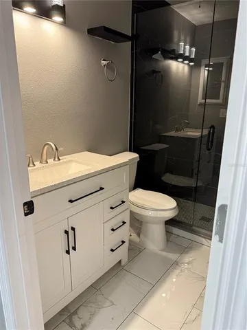 a bathroom with a sink toilet and shower