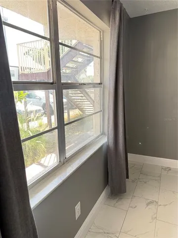 a view of an empty room with a window