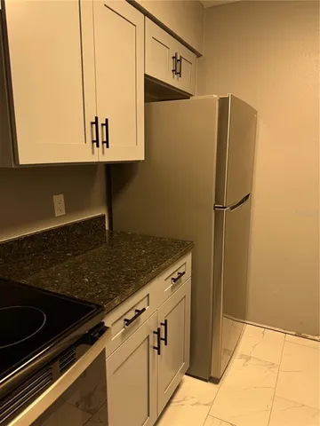 a kitchen with a refrigerator and a sink