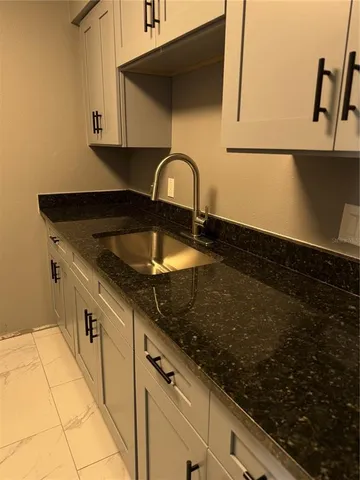 a close view of a sink a counter space and cabinets in the kitchen
