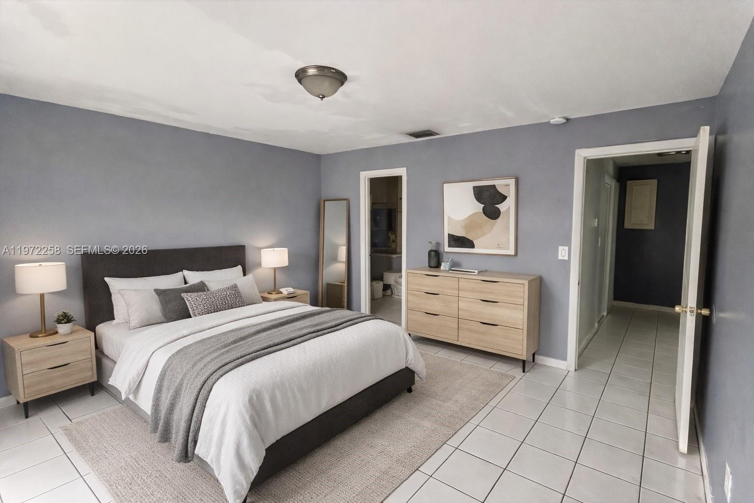 10900 Northwest 7th Street, Unit 101 Miami, FL 33172 - Photo 7 of 10 a bedroom with a bed and a dresser