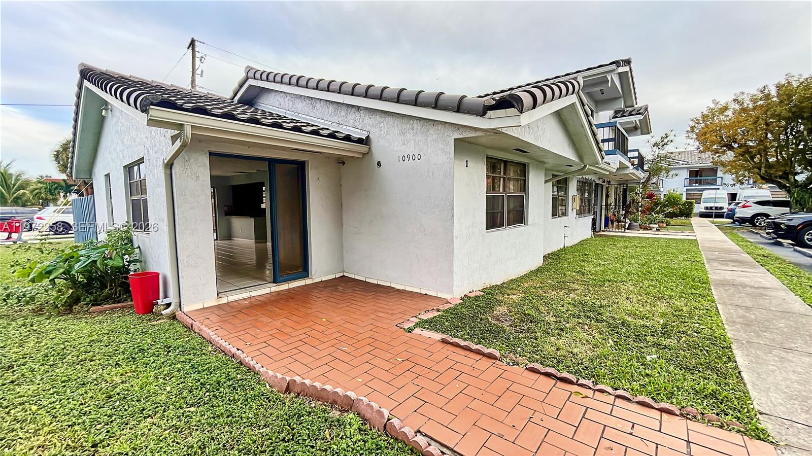 10900 Northwest 7th Street, Unit 101 Miami, FL 33172 - Photo 10 of 10 a view of a house with a porch