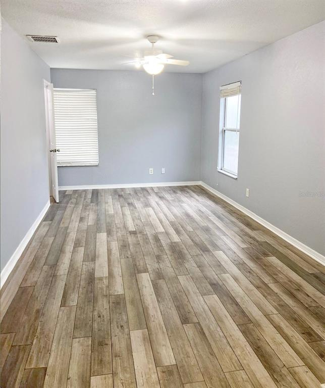141 South Hiawassee Road Orlando, FL 32835 - Photo 12 of 30 wooden floor in an empty room with a window