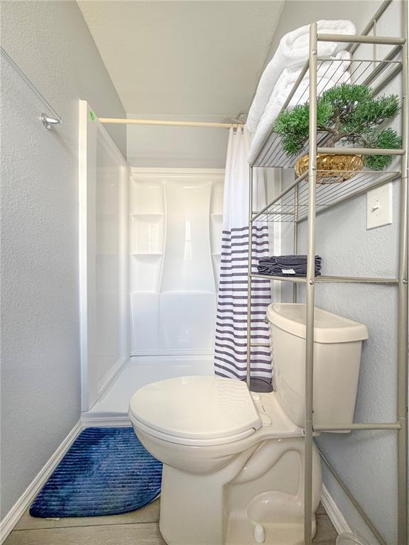 141 South Hiawassee Road Orlando, FL 32835 - Photo 20 of 30 a bathroom with a toilet and a shower