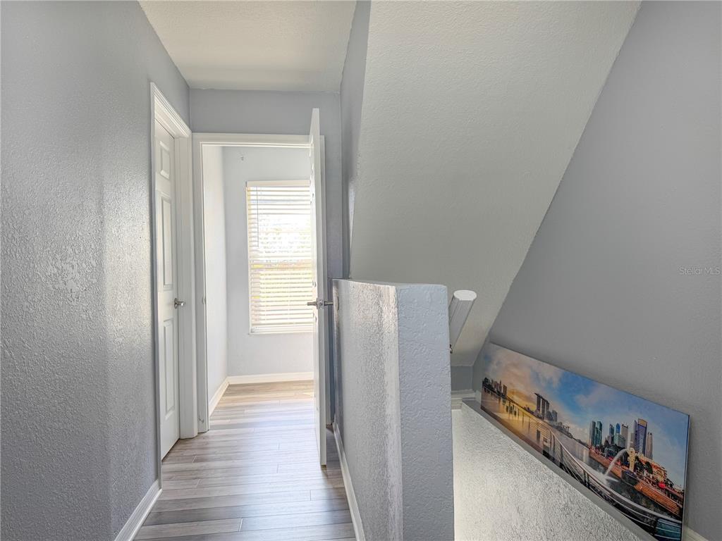 141 South Hiawassee Road Orlando, FL 32835 - Photo 21 of 30 a view of a hallway with wooden floor and stairs
