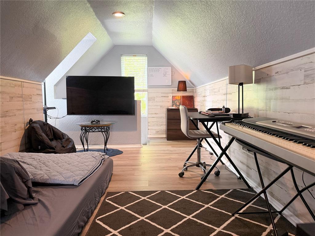 141 South Hiawassee Road Orlando, FL 32835 - Photo 24 of 30 a living room with furniture and a flat screen tv