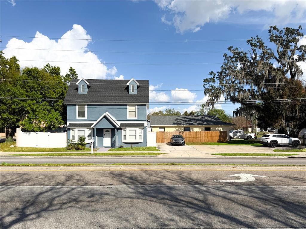 141 South Hiawassee Road Orlando, FL 32835 - Photo 3 of 30 a view of a house with a big yard and large trees