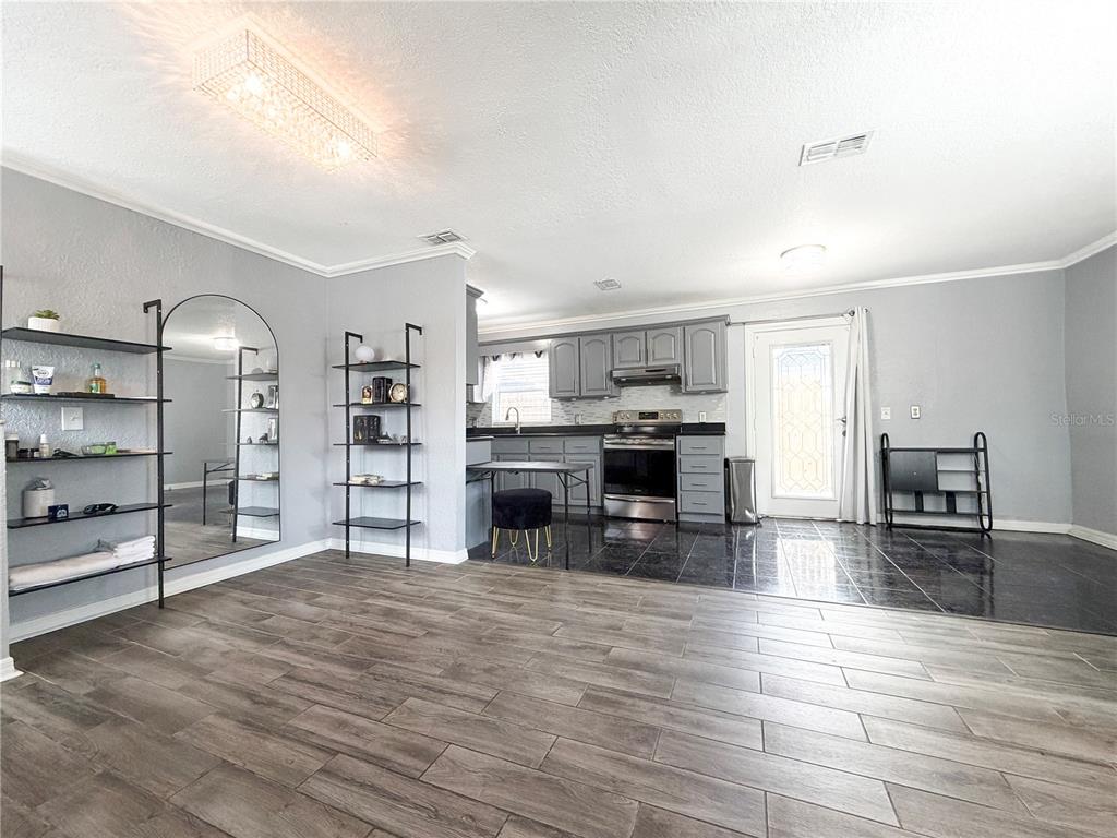 141 South Hiawassee Road Orlando, FL 32835 - Photo 4 of 30 a large kitchen with cabinets and wooden floor