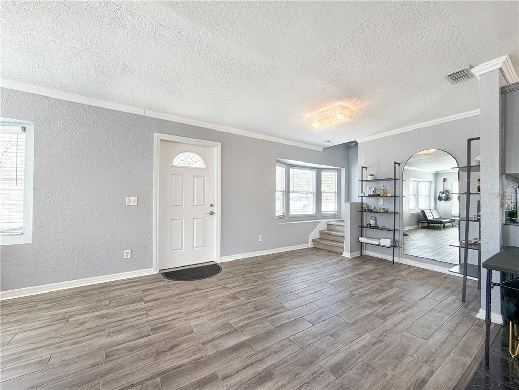 141 South Hiawassee Road Orlando, FL 32835 - Photo 5 of 30 an empty room with wooden floor and windows