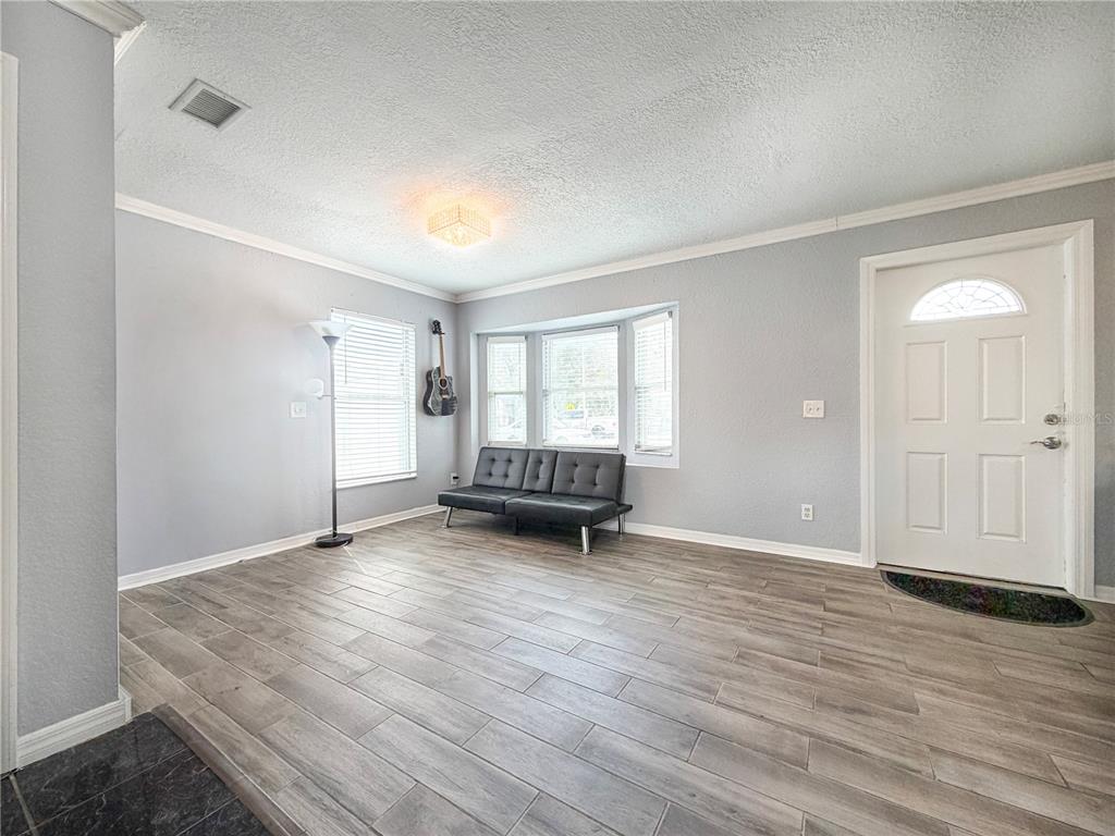 141 South Hiawassee Road Orlando, FL 32835 - Photo 8 of 30 an empty room with wooden floor and windows