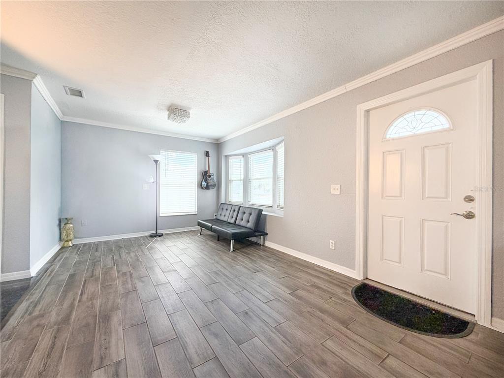 141 South Hiawassee Road Orlando, FL 32835 - Photo 9 of 30 an empty room with wooden floor and a window