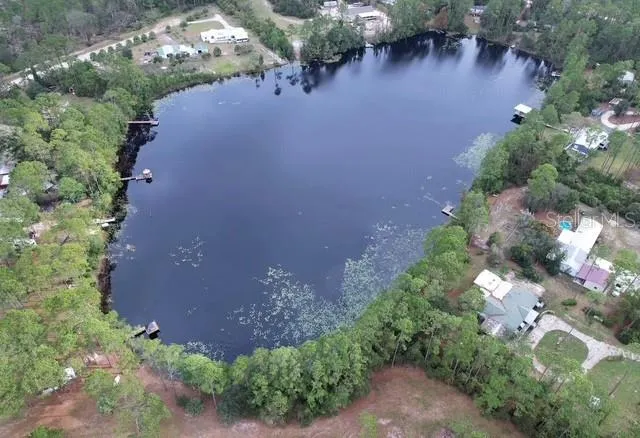 an aerial view of a house with yard