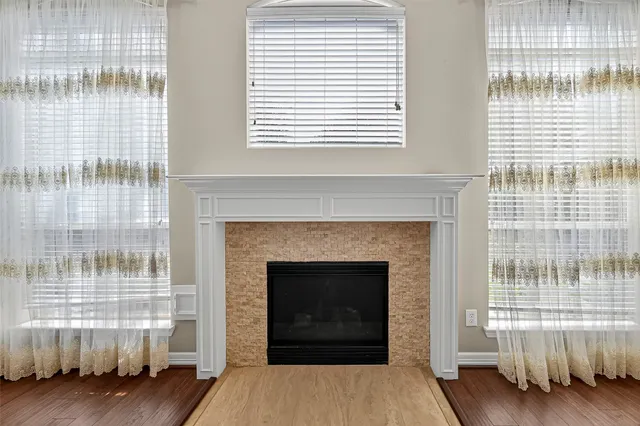 a living room with a fireplace and a window