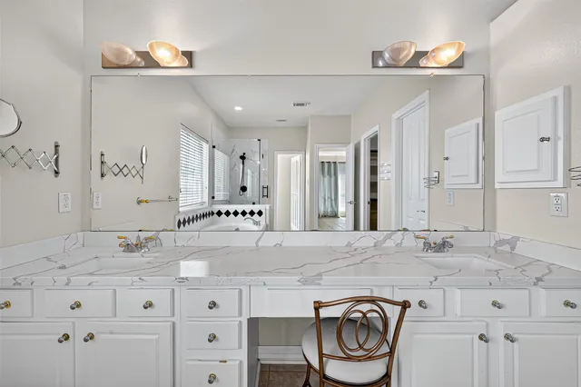 a bathroom with granite countertop a sink and a mirror
