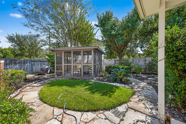 a view of a house with backyard and sitting area