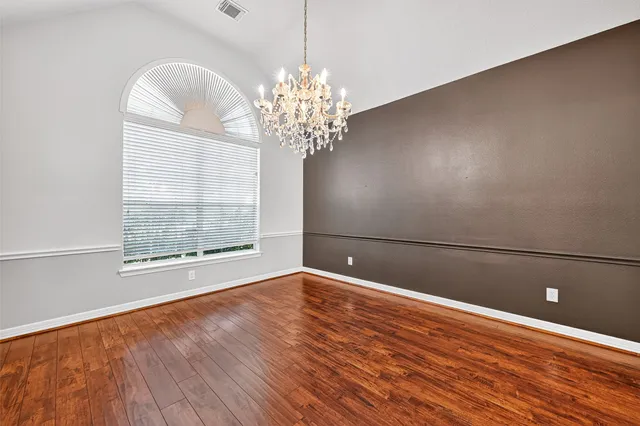 a view of wooden floor and windows in a room