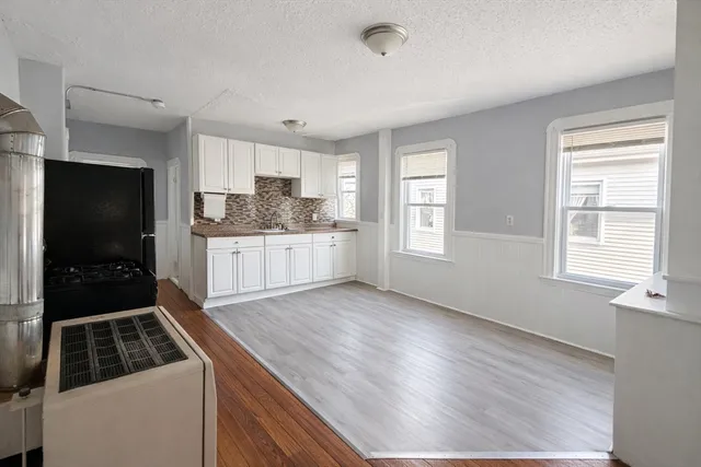 a kitchen with granite countertop a sink and a stove top oven