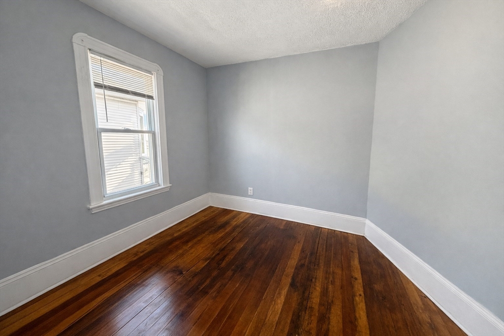 159 Frederick Street, Unit 3E New Bedford, MA 02744 - Photo 7 of 8 a view of wooden floor in a room