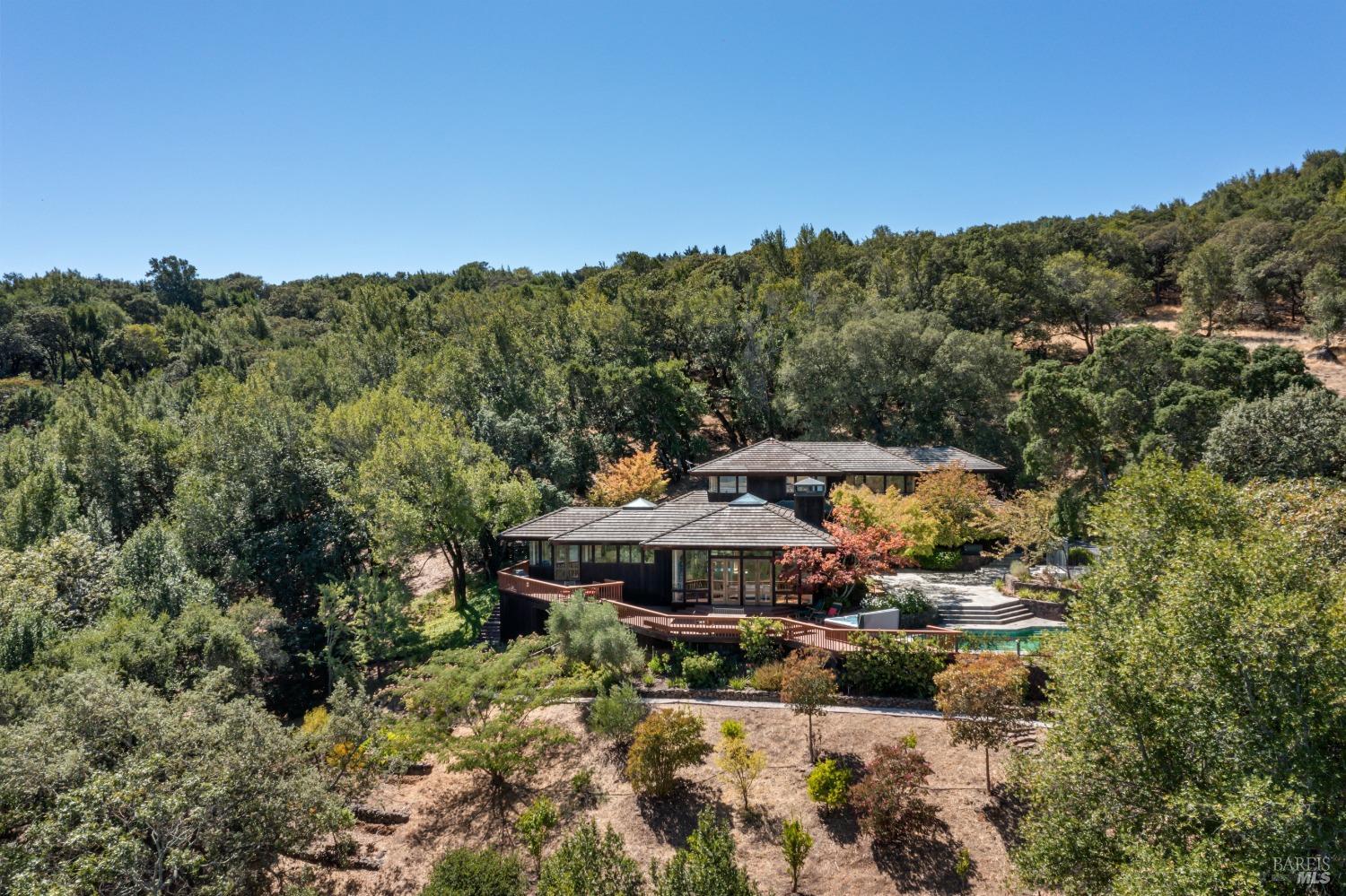a view of a house with a mountain yard and outdoor seating