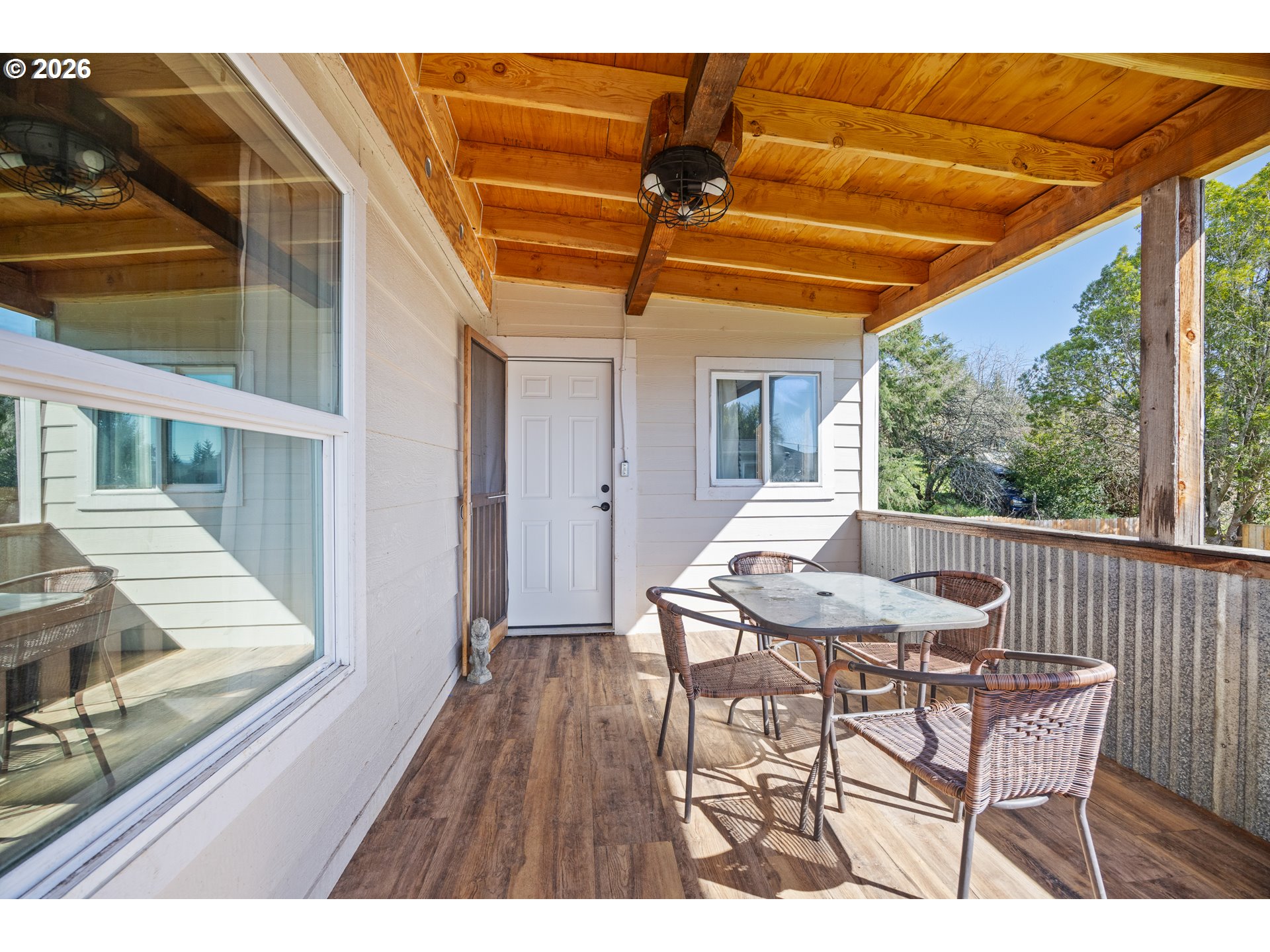 1932 East Willow Street Myrtle Point, OR 97458 - Photo 23 of 28 a view of a patio with table and chairs with wooden floor and fence