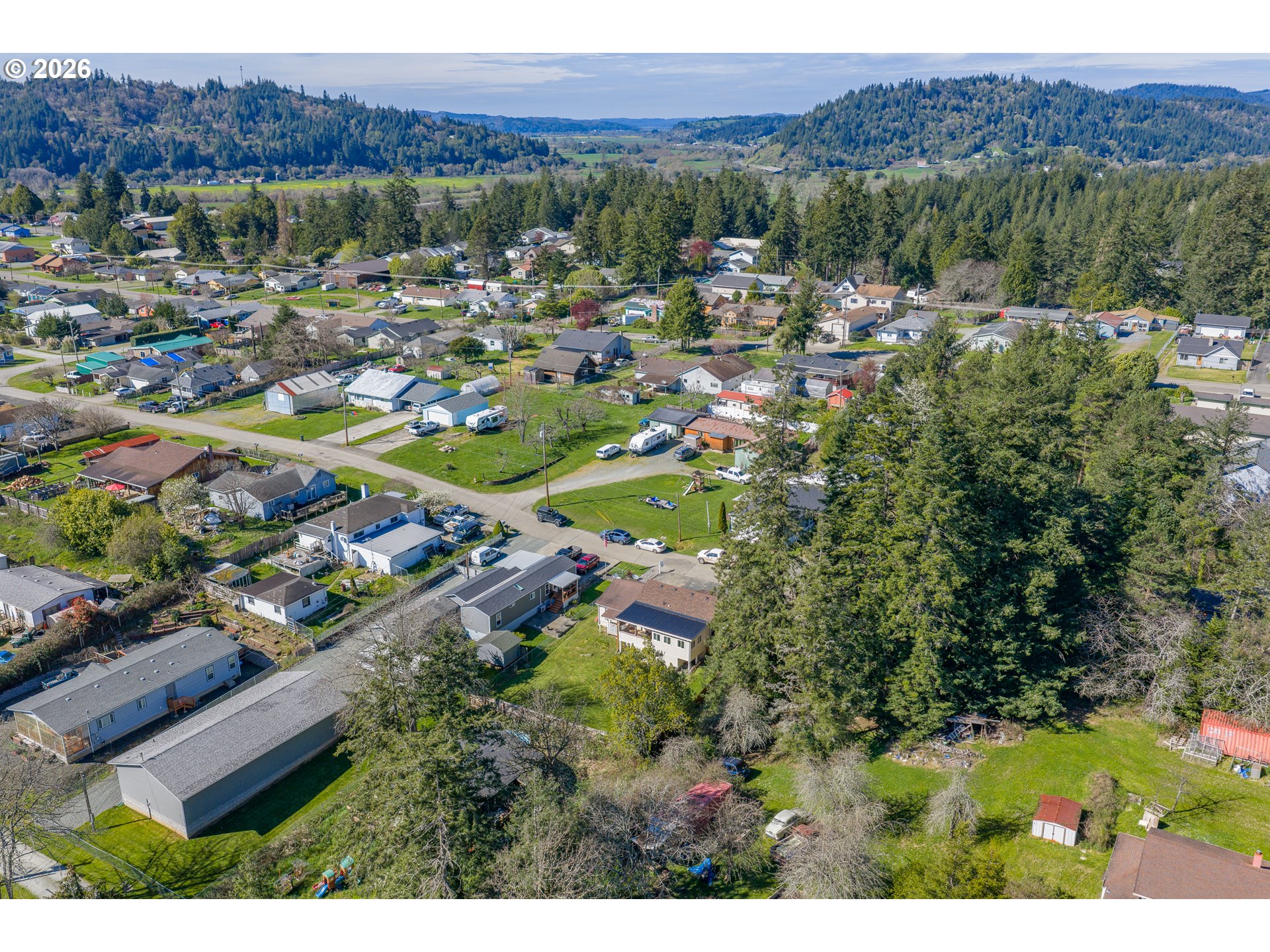 1932 East Willow Street Myrtle Point, OR 97458 - Photo 24 of 28 a view of a city with lush green forest