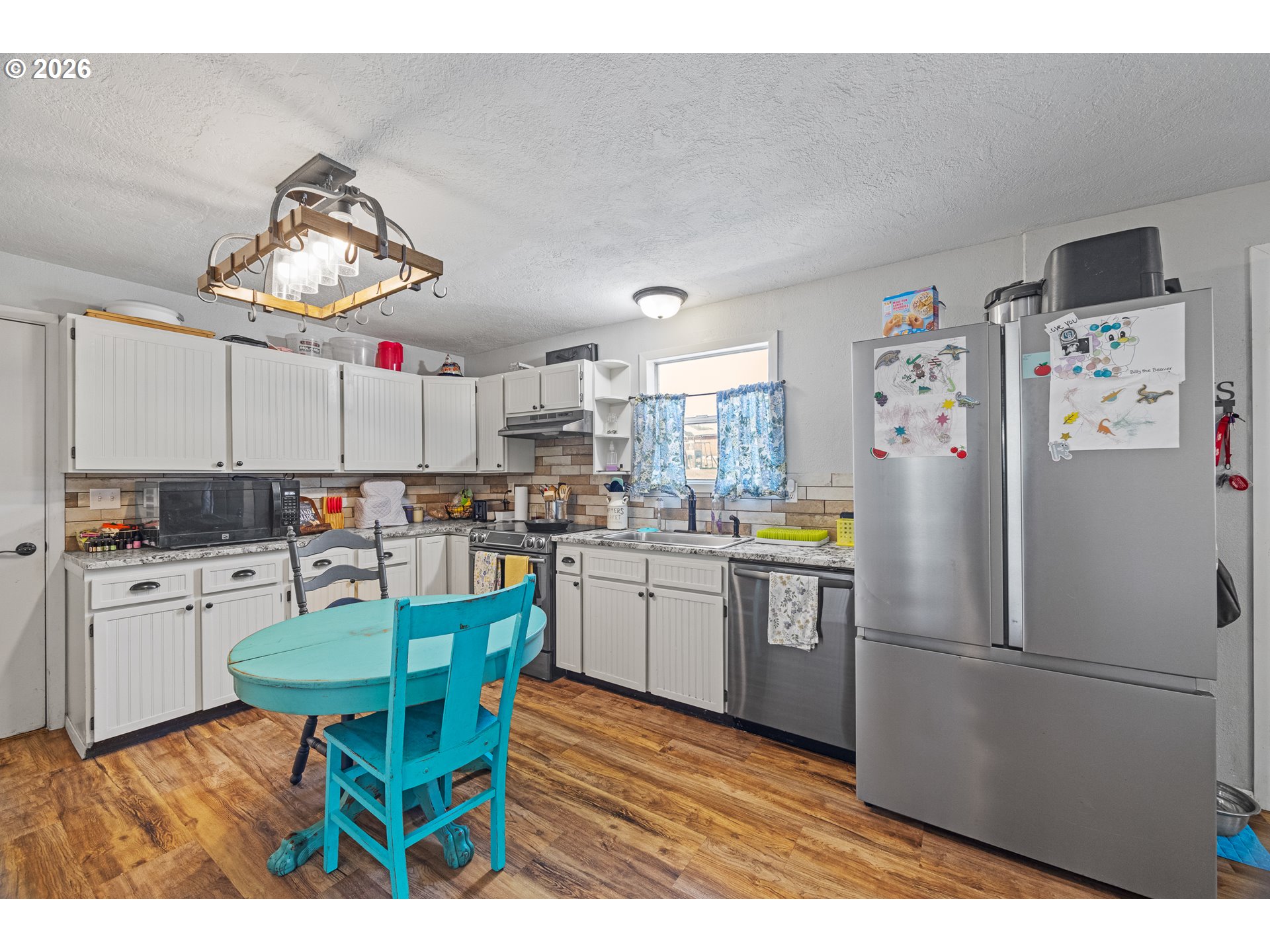 1932 East Willow Street Myrtle Point, OR 97458 - Photo 8 of 28 a kitchen with granite countertop stainless steel appliances a table and chairs