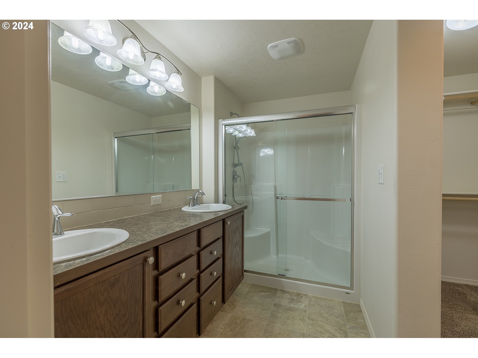 941 South 55th Street Springfield, OR 97478 - Photo 15 of 24 a bathroom with a granite countertop sink a mirror and a shower