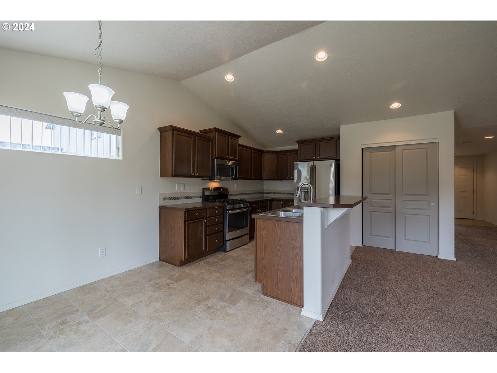 941 South 55th Street Springfield, OR 97478 - Photo 10 of 24 a kitchen with refrigerator and microwave