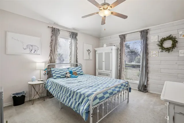 a bedroom with bed and a chandelier