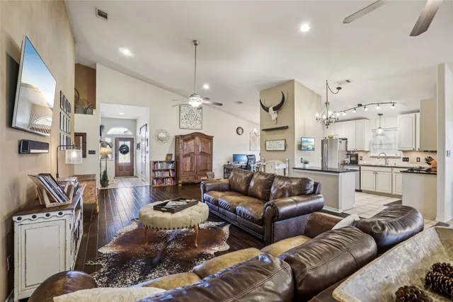 a view of a hallway to a livingroom with furniture