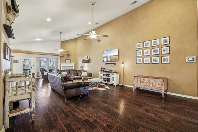 a living room with furniture kitchen view and a chandelier