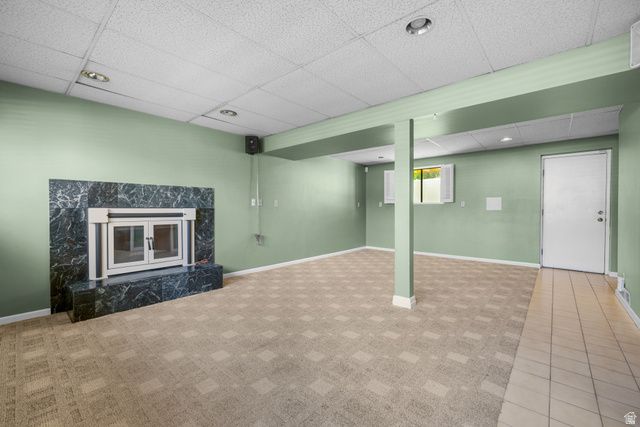 2088 Falcon Way Sandy, UT 84093 - Photo 31 of 46 Spacious room featuring a prominent fireplace with a dark, veined stone surround and hearth