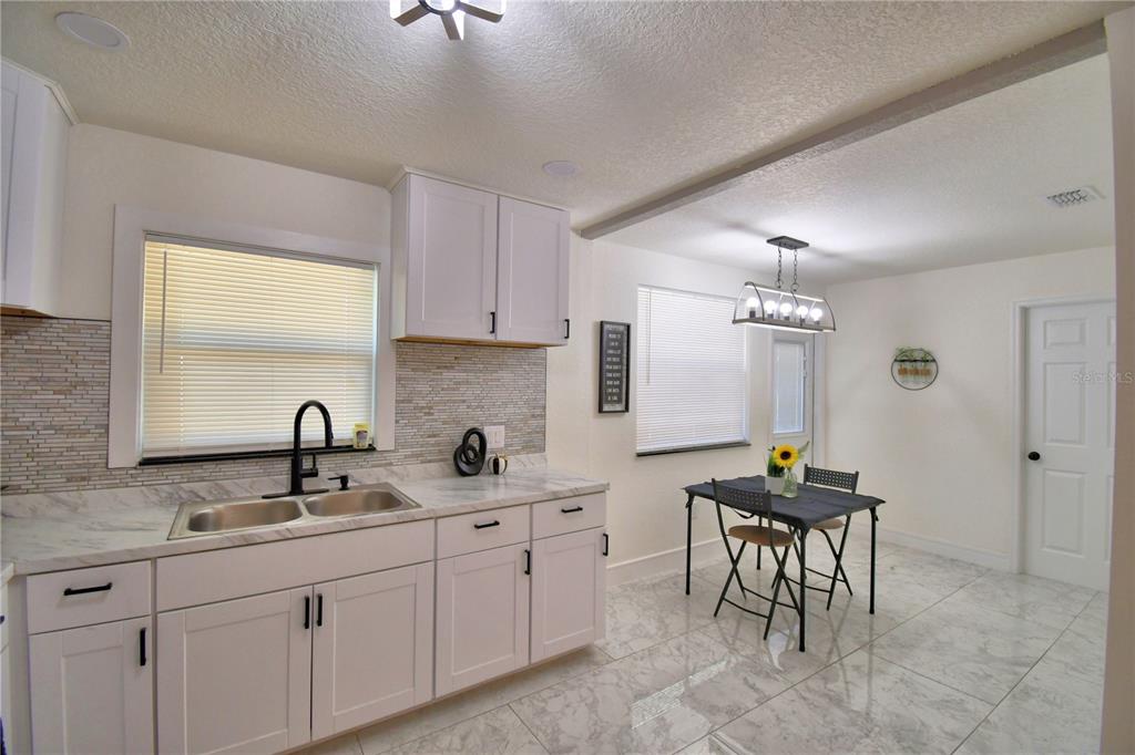 6960 2nd Street Mulberry, FL 33860 - Photo 15 of 39 a kitchen with sink and cabinets